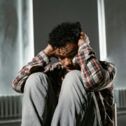 A Frightened Man Sitting Alone on a Chair